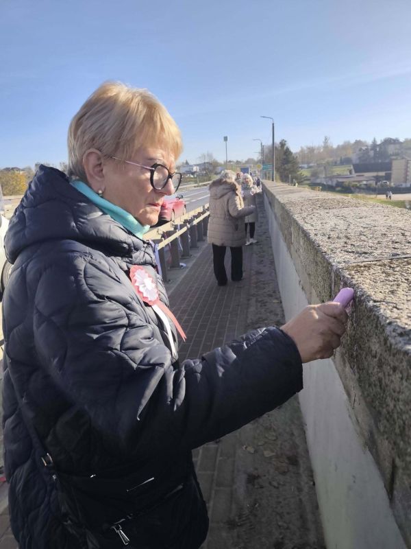Seniorka pisze kredą po moście